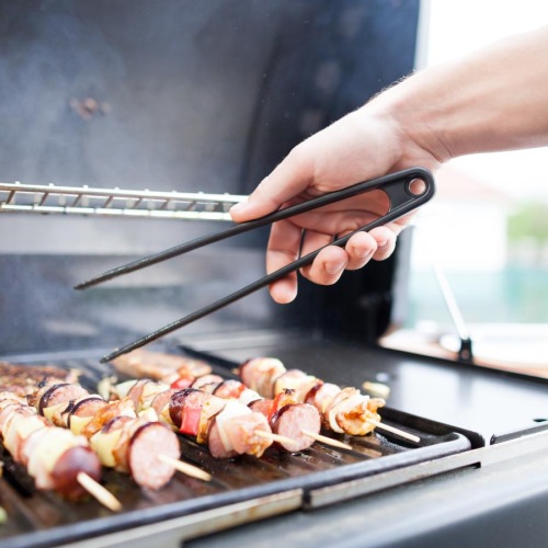 a person cooking food on a grill
