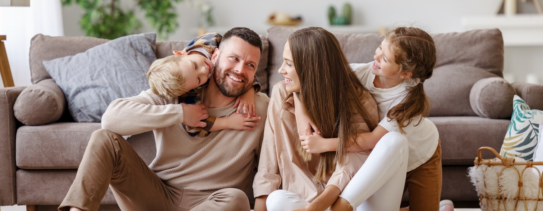 a family sitting in front of a couch
