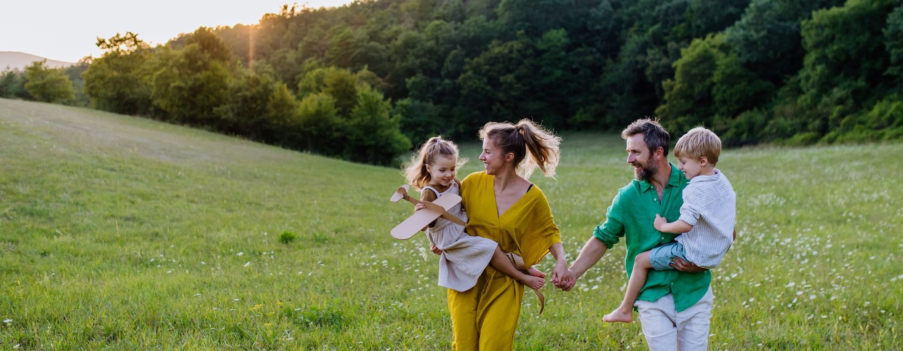 a group of people running in a grassy field